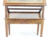 a small wooden table with a glass top on it