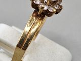 an image of a gold ring with a flower design on it