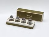 two salt and pepper shakers in a box with a box of salt