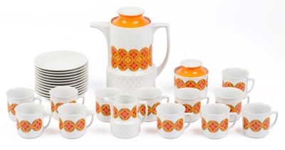 many cups and a pitcher with orange designs on them