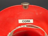 a close up of a red bowl with a label on it