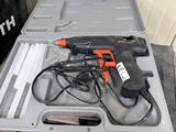 a box with a drill and other tools on top of it
