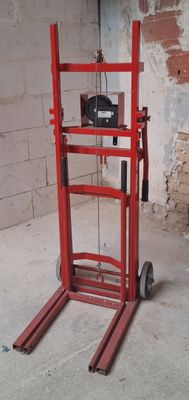 a red hand truck that is sitting in a room