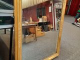 a large mirror sitting on the floor in a room