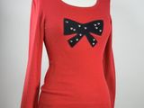 red sweater with black bow detail on shoulders