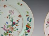 two plates with flowers painted on them on a table