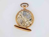 an image of a gold pocket watch on a white surface