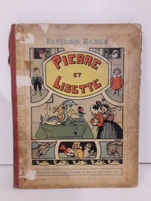 un vieux livre pour enfants sur lequel figure l'image d'un chien et d'un chat