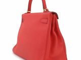 a red leather handbag on a white background