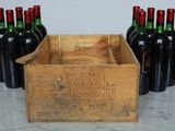 several bottles of wine are lined up in a wooden crate