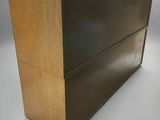 an image of a black and gold chest of drawers on a grey background