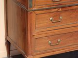 a marble top dresser with a mirror on top of it