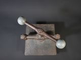 a close up of a metal object with two balls on it