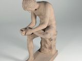 statue of a man sitting on a rock with his hands on his knees