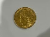 a gold coin sitting on top of a white table