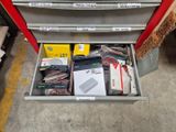 a metal tool box with many items inside of it
