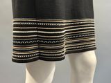 a close up of a mannequin wearing a skirt with a black and white pattern