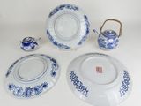 several pieces of blue and white porcelain are arranged on a table