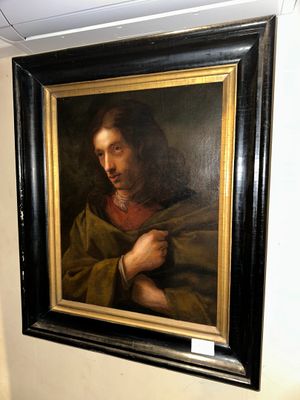 a picture of a painting of jesus hanging on a wall
