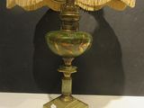 a lamp that is sitting on a table with a lamp shade on it