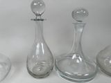 three glass decanters sitting on a table next to each other