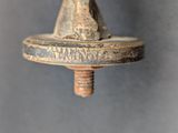 a close up of a metal object on a gray background
