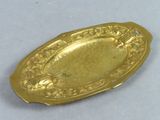 gold plate with a design of flowers and birds