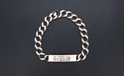 a silver bracelet with a bar on it
