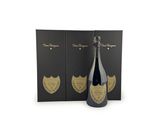 a bottle of champagne in front of two black boxes