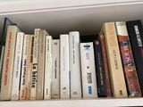 many books that are on a shelf in the room