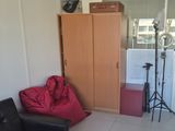 a red bean bag sitting in a living room next to a chair