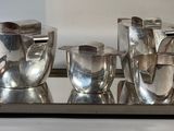 a tray with silverware on it on a white surface