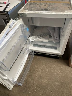 a refrigerator that is open and sitting on the floor