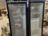 two refrigerators that are next to each other in a room