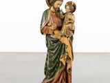 an image of a statue of jesus holding a child