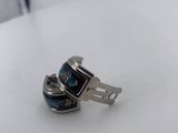a close up of a ring on a table with a white background