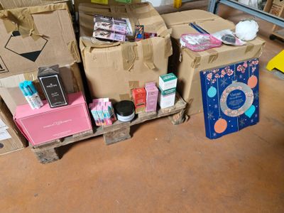 many boxes that are sitting on a pallet in a room