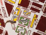 a red and white sign with a map on it