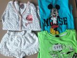 three children ' s clothing items are sitting on a cardboard box