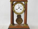 a wooden clock that is sitting on a table