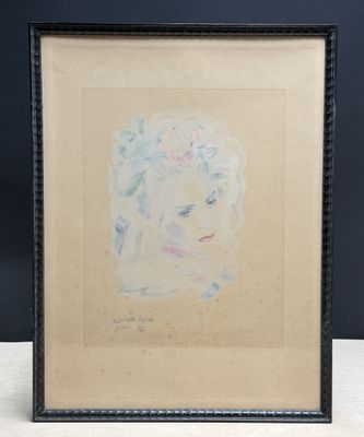 a painting of a woman ' s face is shown in a black frame