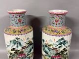 pair of chinese vases with landscape and flowers on them