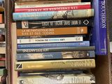 a lot of books that are stacked on top of each other