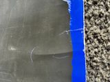 a piece of blue tape taped to a piece of black paper
