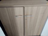 a cabinet with two doors and a drawer on top of it