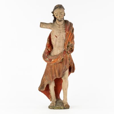 an old statue of a man holding a baseball bat on a white background