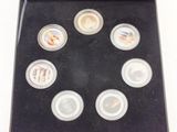 a black box with six different colored coins in it