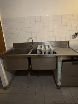 an image of a kitchen with a sink and a stove