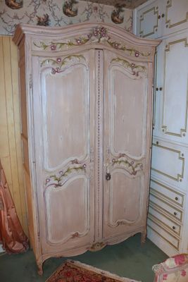 a large armoire in the corner of a room