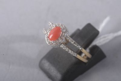sterling silver ring with a coral stone and diamonds